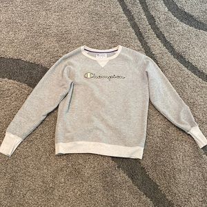This item is a Champion crew neck that is gray. It is a women’s medium.